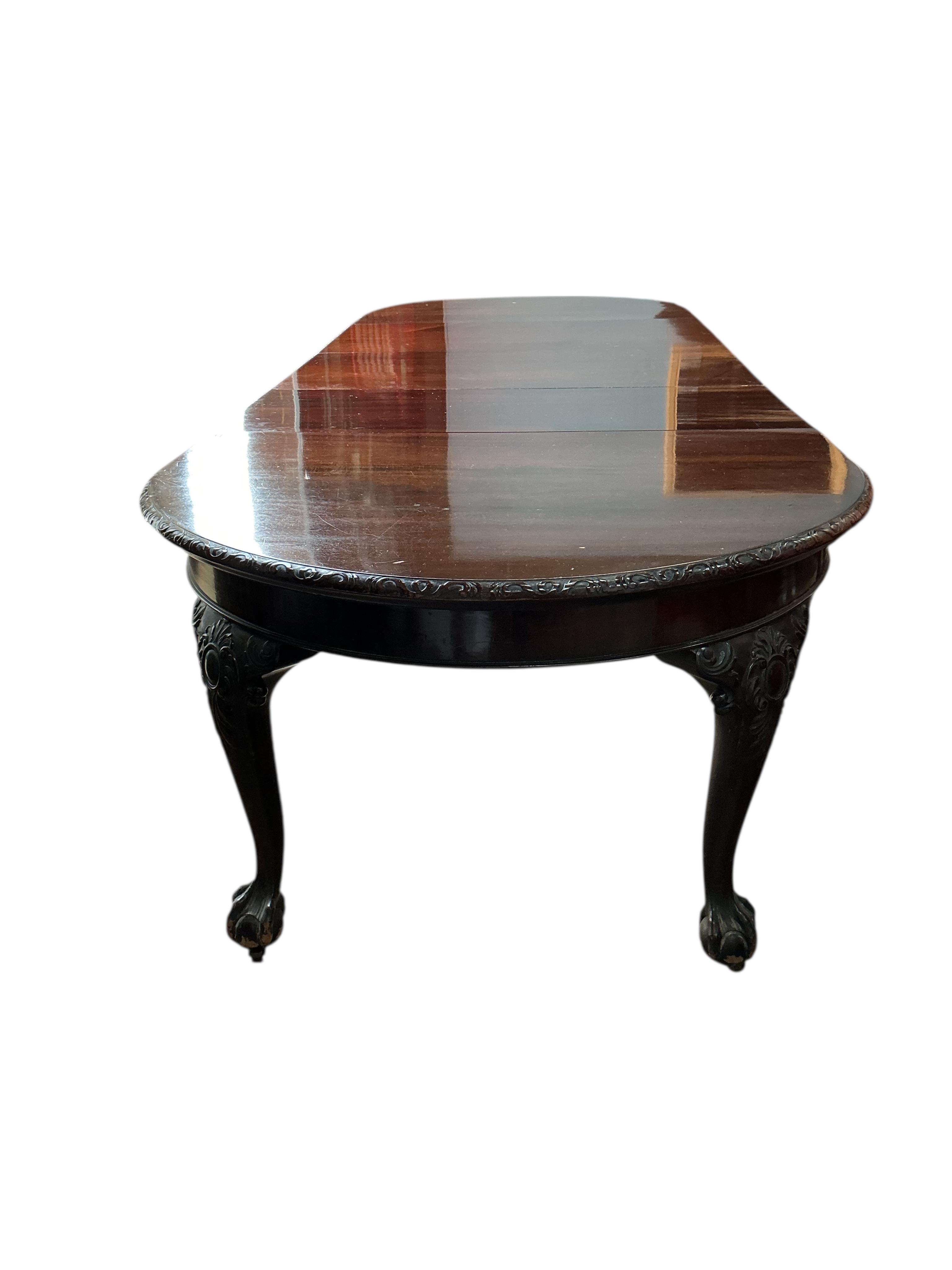 An early 20th century Chippendale Revival mahogany extending dining table, on cabriole legs with claw and ball feet, width 340cm extended, three spare leaves, depth 120cm, height 77cm